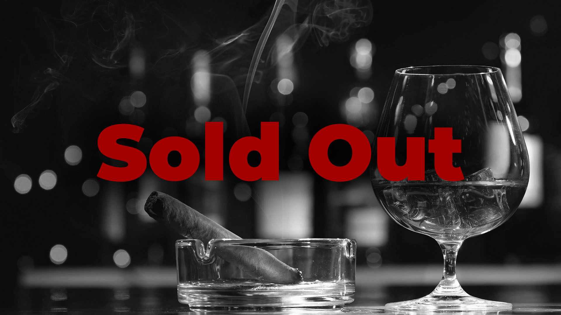 Glass of whiskey or cognac with ice cubes and smoking cigar in black and white with SOLD OUT text